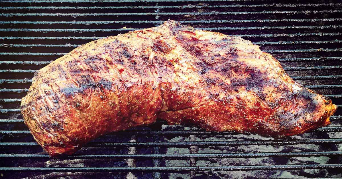 BBQ tri tip roast cooking on a charcoal grill